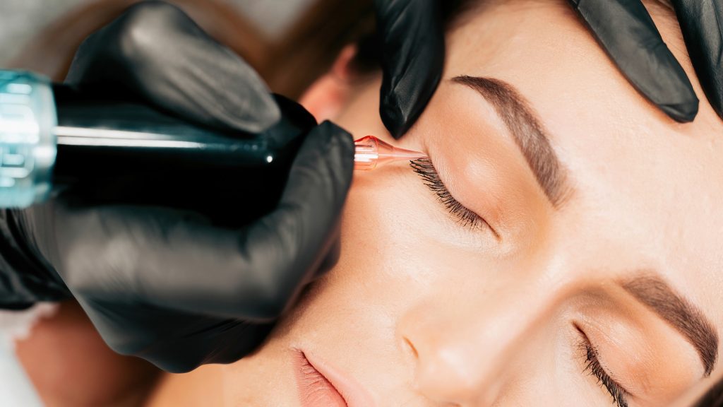 Make-up master performs the procedure of permanent eyebrow makeup